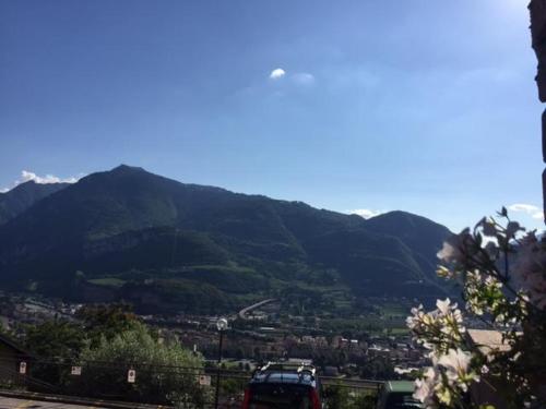 a car parked on a road in front of a mountain at Casa Lampone in Trento