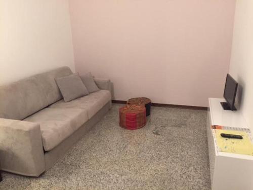 a living room with a couch and a tv at Casa Lampone in Trento