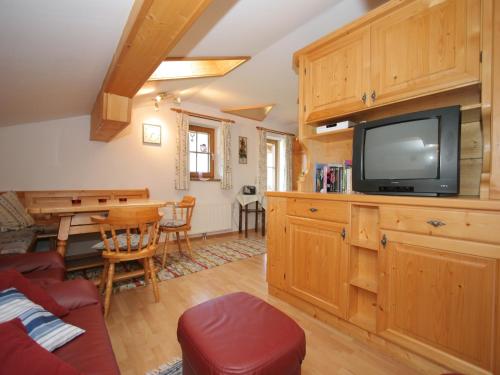 a living room with a television and a table at Apartment in Embach near Gastein Ski Area in Embach