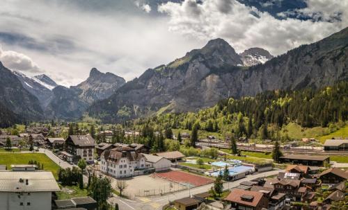 a town in a valley with mountains in the background at Lovely & great equipped wooden Alp Chalet flat in Kandersteg