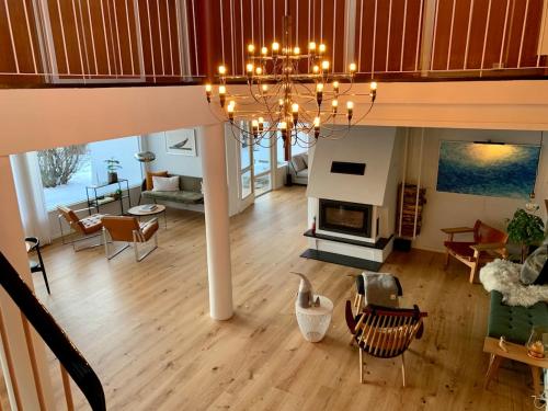 a living room with a chandelier and a living room at Large Architect Designed Home in City Centre in Hamar