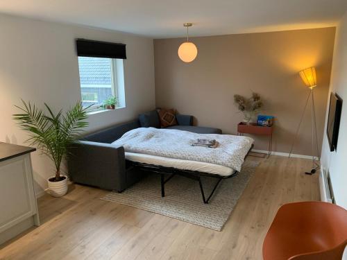 a living room with a couch and a table at Large Architect Designed Home in City Centre in Hamar