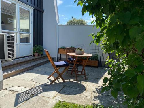 a patio with a table and a chair at Large Architect Designed Home in City Centre in Hamar