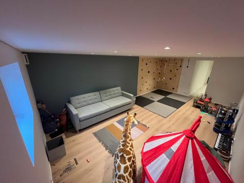 a living room with a couch and a giraffe in a room at Large Architect Designed Home in City Centre in Hamar