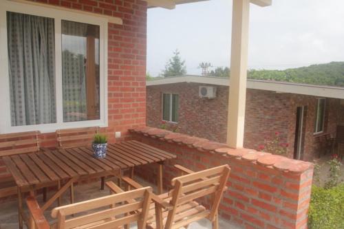 a patio with a wooden table and two chairs at Hotel Anchor in Sinemorets