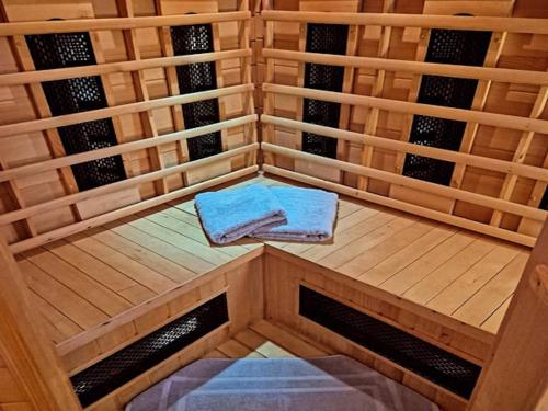 a sauna with two towels sitting on a wooden platform at Holiday Home Muhr near Katschberg Ski Area in Muhr