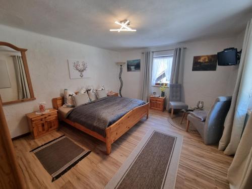 a bedroom with a bed and a chair and a window at Holiday Home Muhr near Katschberg Ski Area in Muhr