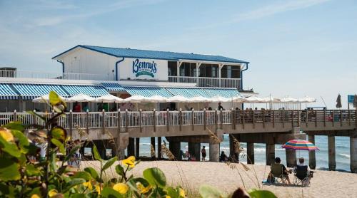 a restaurant on the beach next to a pier at Charming home near art & culture in Greenacres City