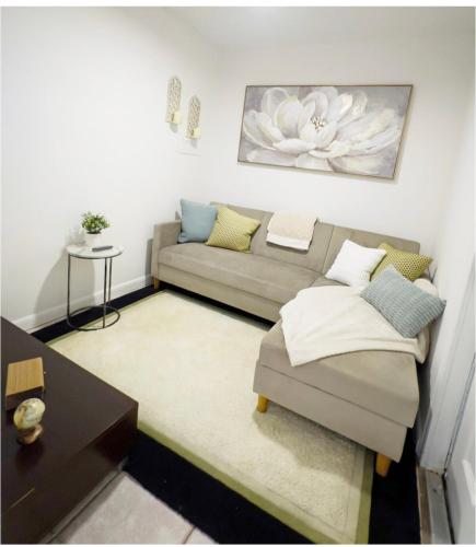 a living room with a couch and a table at Charming home near art & culture in Greenacres City