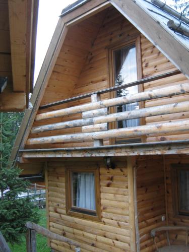 a log cabin with windows on the side of it at Etno kuća ''Nada'' in Jahorina
