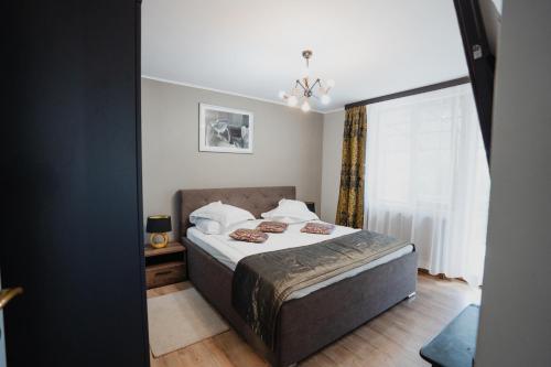 a bedroom with a bed and a window at Cincis by the Lake in Cinciş