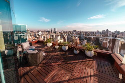 a balcony with potted plants and a view of the city at Holiday Inn Rosario by IHG in Rosario