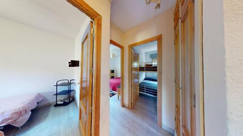a room with a bed and a door to a bedroom at Chalet BS in Albalate de Zorita