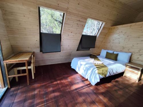 a bedroom with a bed and a desk in a cabin at Hippo Lagoon Luxury A Frame On Deck in Maun