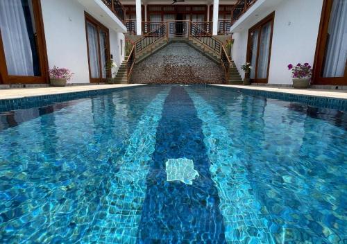 a swimming pool with blue water in a building at Tangalle Villa in Tangalle
