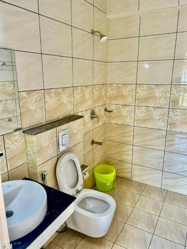 a bathroom with a toilet and a sink at Ikigai Business Rooms by Zoliva Homes in Cochin
