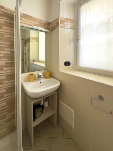 a bathroom with a sink and a mirror at BelSorrisoVarese - Elegance City Residence Private Parking -Reservation Required- in Varese