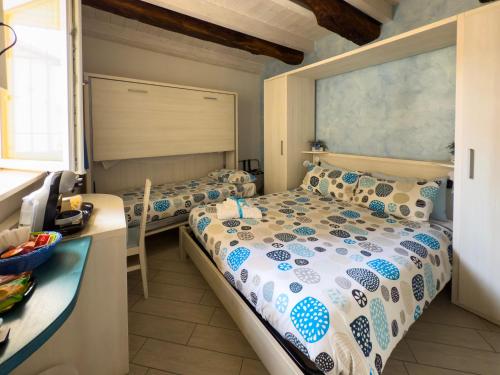 a bedroom with two beds and a counter at BelSorrisoVarese - Elegance City Residence Private Parking -Reservation Required- in Varese