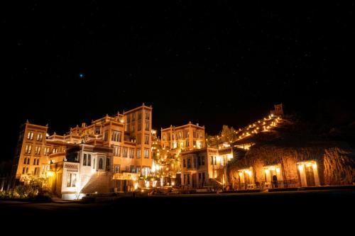 a large building is lit up at night at Eden Boutique Hotel in Tamellalt