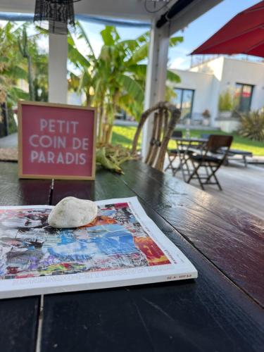 a book on a table with a rock on it at Villa Le Sud in Cassis