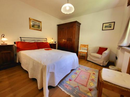 a bedroom with a large white bed and a chair at Molo 2 Pila in Gressan