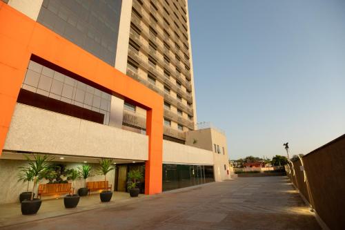 an apartment building with orange accents on the side of it at Intercity BH Expo in Belo Horizonte