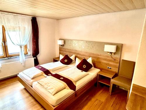 ein Schlafzimmer mit großem Bett und Fenster in der Unterkunft Gasthof zur Post in Zwiefalten