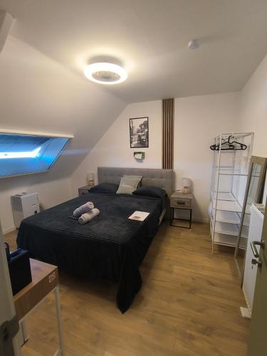 a bedroom with a bed with a black comforter at 2Bangkok residence in Ghent