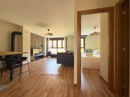 a living room with a bed and a dining room table at 1692m Valdelinares in Valdelinares