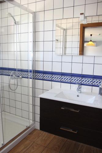 a bathroom with a sink and a shower at Casa do Ferrador in Mirandela