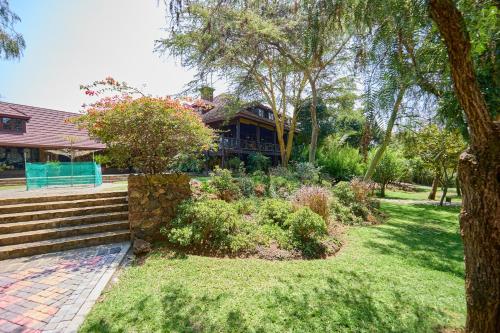 a house with a garden in front of it at Charity Chalet in Naivasha