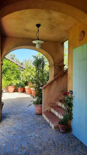 an entrance to a building with stairs and potted plants at Casa Nonna Ada in Cisterna dʼAsti