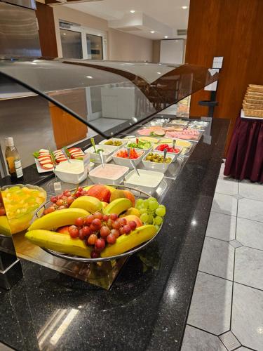 a buffet with a bunch of fruit on a counter at Hotel Löwen in Meckenbeuren