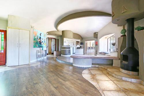 a large kitchen with a stove in the middle of a room at Suite SolVista in Cape Town