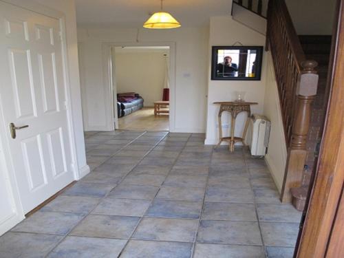 a hallway with a tile floor in a house at Cathedral Court in Ennis