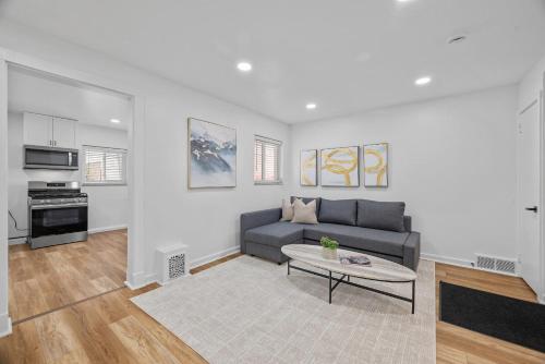 a living room with a couch and a table at Pittsburgh Millvale Modern and Cozy 1 Bedroom Apartment with Parking in Millvale