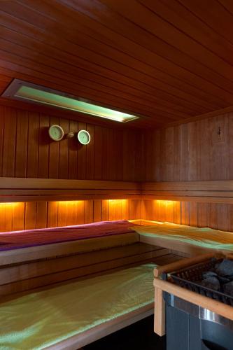a sauna with a bed in the middle of it at Hôtel Restaurant et Spa Au Tilleul in Labaroche