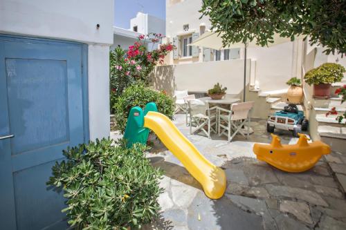 a playground with a slide in a yard at Tiniotissa Studios in Tinos