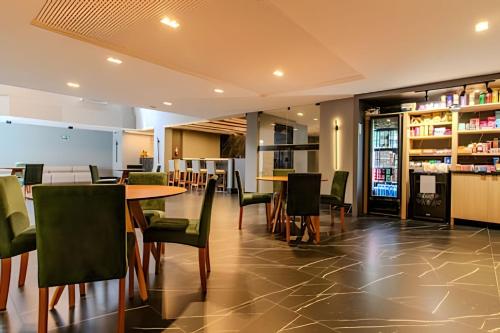 a restaurant with chairs and a table and a bar at Flats a 50m do mar Legacy Suites - MyFlats Hospedagens in Tambaú