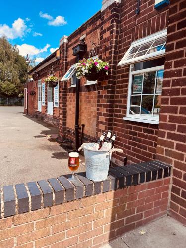 a brick building with a bucket on the side of it at Minworth Lodge in Minworth