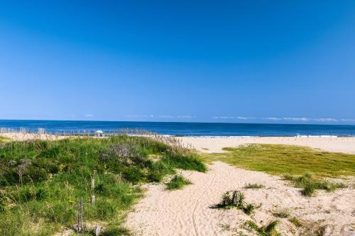 a sandy beach with the ocean in the background at Striper #20A-CAC in Buxton