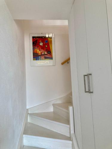 a staircase in a house with a painting on the wall at Ferienwohnung Stefanie in Polling