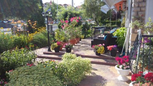 a garden with potted plants and flowers on a patio at Barbara Vendégház in Balatonfüred