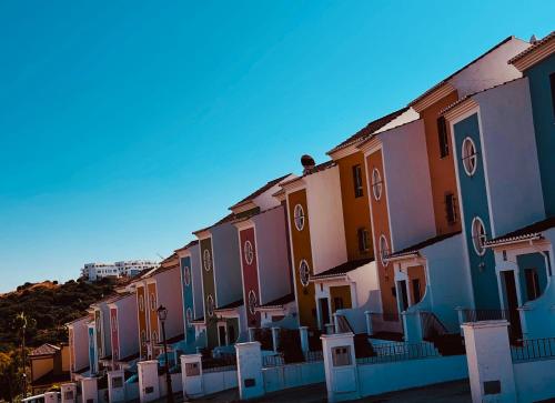 a row of colorful houses on a hill at Casa Dos Palomas in Bahia de Casares
