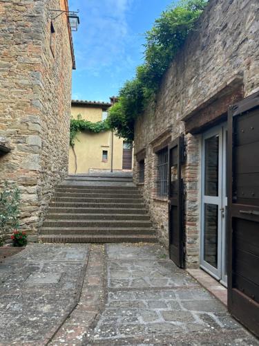 a stairway leading up to a brick building at Fairytale apartment in 12th century castle - Umbria in Monte lʼAgello