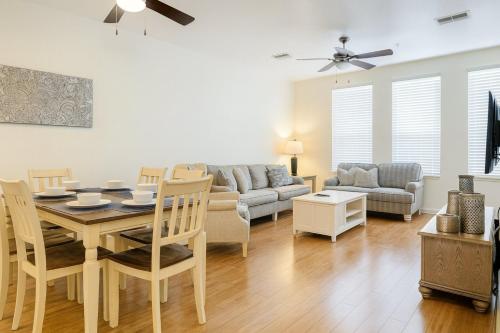 a living room with a table and a couch at 3B/3.5B Vista Cay Resort - 5 min from Universal in Orlando