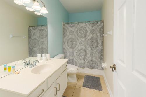 a bathroom with a sink and a toilet and a shower at 3B/3.5B Vista Cay Resort - 5 min from Universal in Orlando
