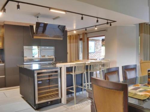 a kitchen with a counter and a bar with chairs at Kruger Park Lodge Unit 268 & Unit 531 in Hazyview