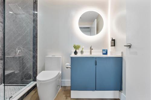a bathroom with a toilet and a sink and a mirror at Private Oasis at Arya in Miami