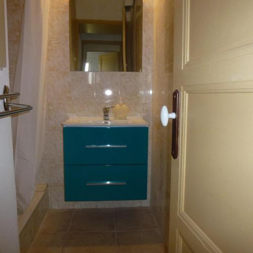 a bathroom with a blue sink and a mirror at Petite marie in Saintes-Maries-de-la-Mer